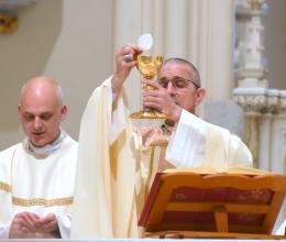 Bishop James Ruggieri holds up the host during the Liturgy of the Eucharist.