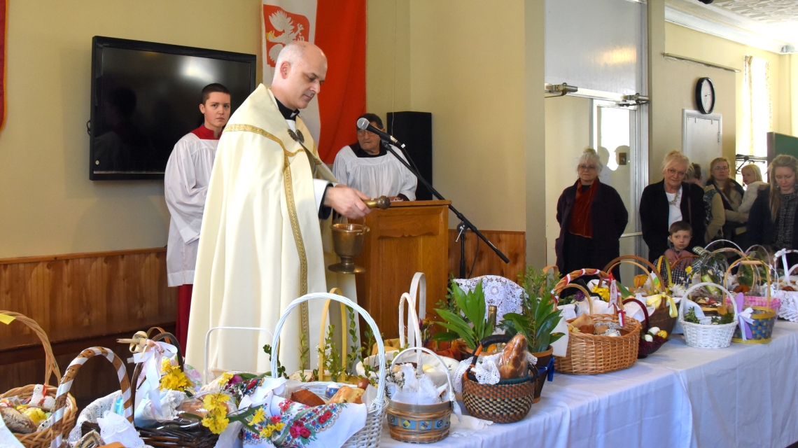 Father Seamus Griesbach blesses Easter baskets.