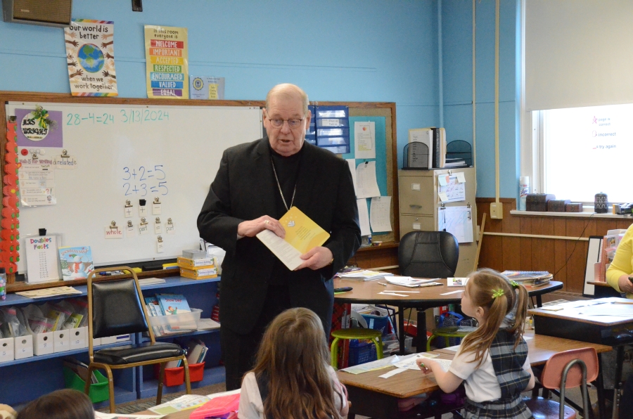 Bishop reading to students in classroom