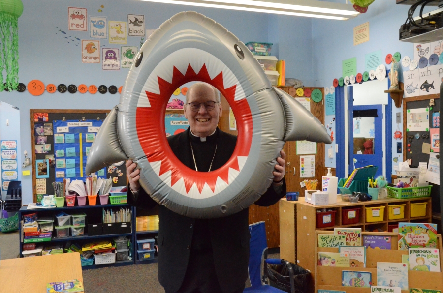 Bishop with shark inflatable to celebrate learning 