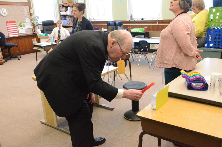 Bishop playing game with student 