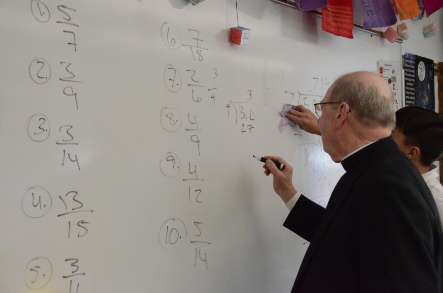 Bishop writing on whiteboard 