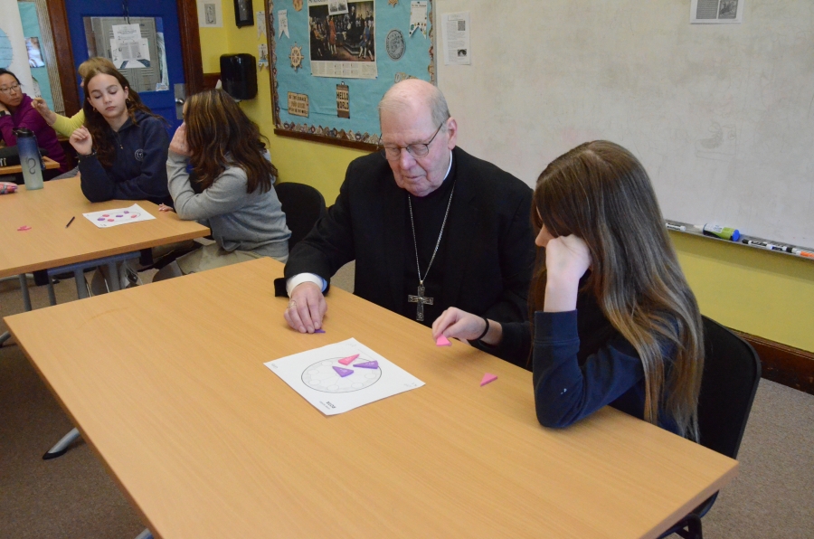 Bishop talking to students in classroom 
