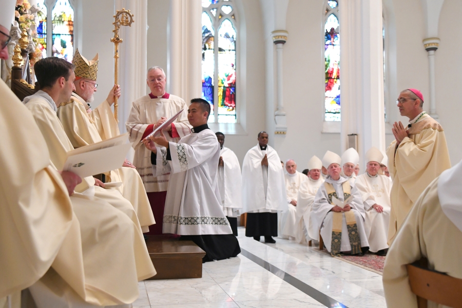 Bishop Ruggieri stands before Cardinal O'Malley.