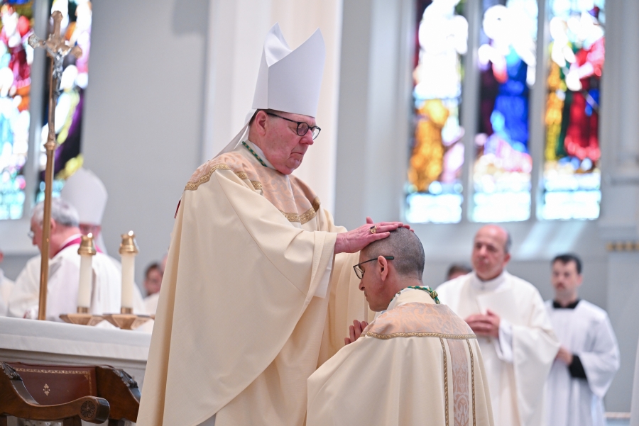Bishop Robert Deeley lays hands on Bishop Ruggieri.
