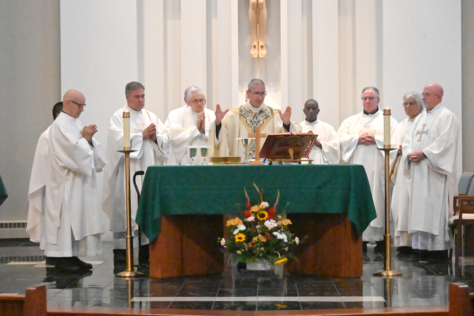 Bishop Ruggieri is surrounded by priests for the Liturgy of the Eucharist.