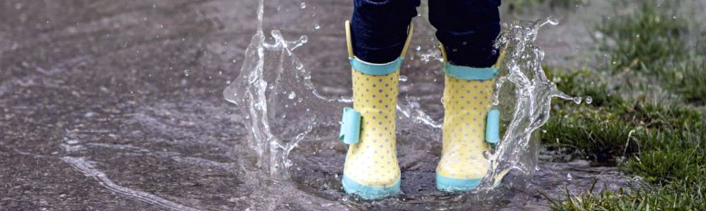 Rain boots splashing in water