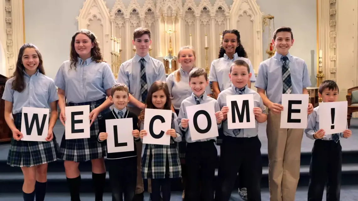 All Saints students with welcome sign.