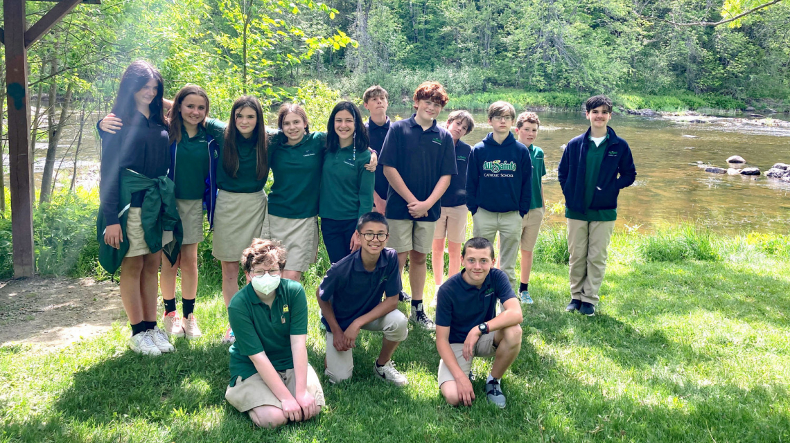 Seventh graders at the edge of Kenduskeag Stream