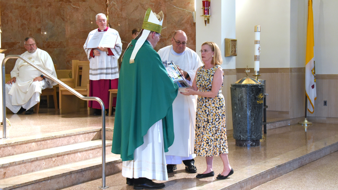The bishop presents the Matthew 25 Award to Barbara Russell.
