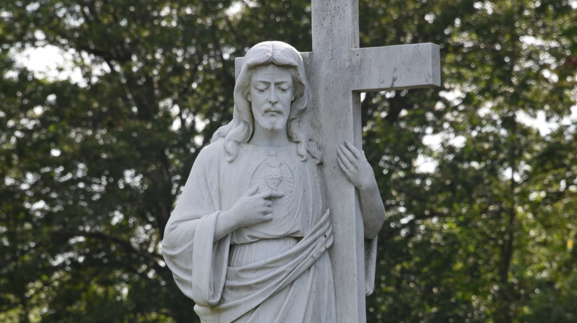 Cemetery statue of Christ with cross