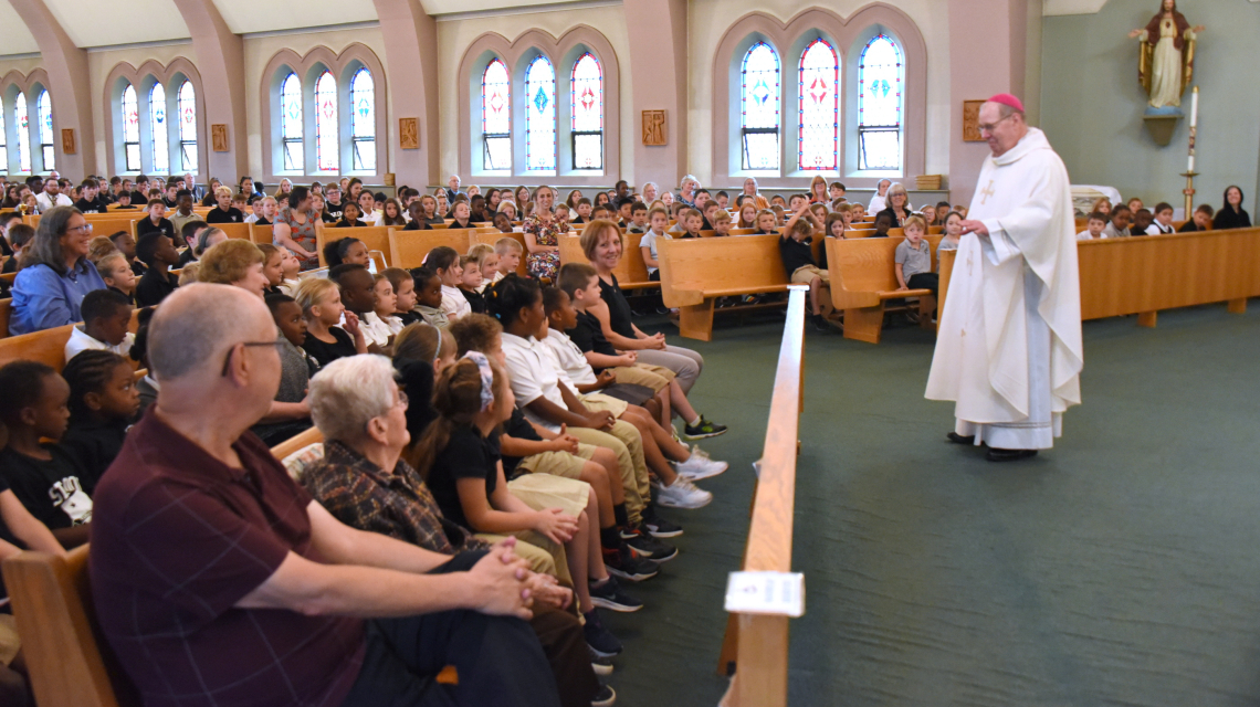 Bishop Deeley talks with students.