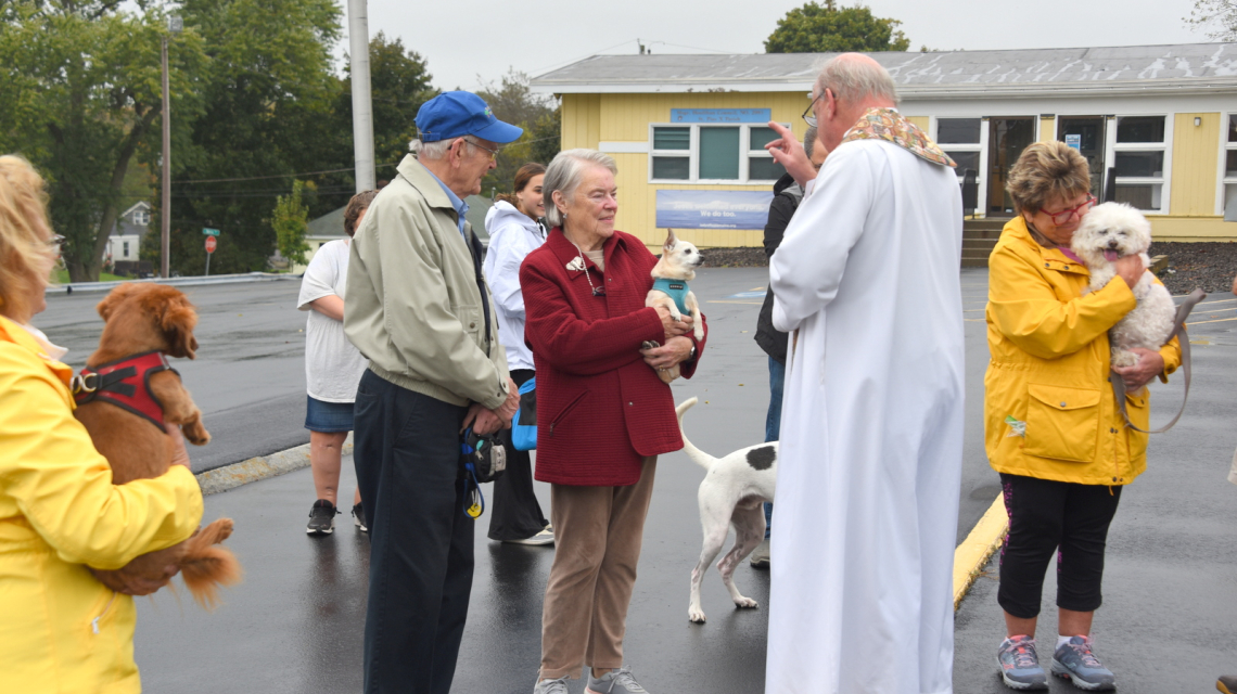 Father Conley blessing a dog.