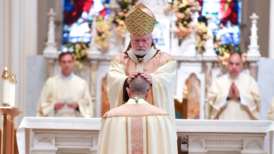 Cardinal Sean O'Malley lays hands on Bishop-elect James Ruggieri.