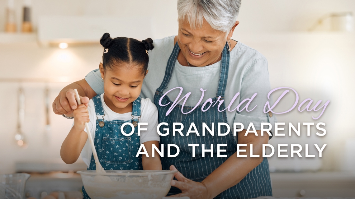 Grandmother with grandaughter wearing aprons.