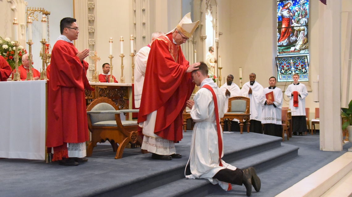 Bishop James Ruggieri lays hands on Deacon Matthew Valles