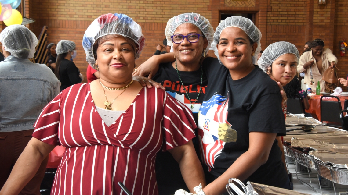 Three women volunteers serving food.