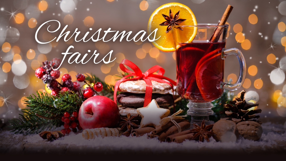 Glass of cider with berries and the words Christmas Fairs