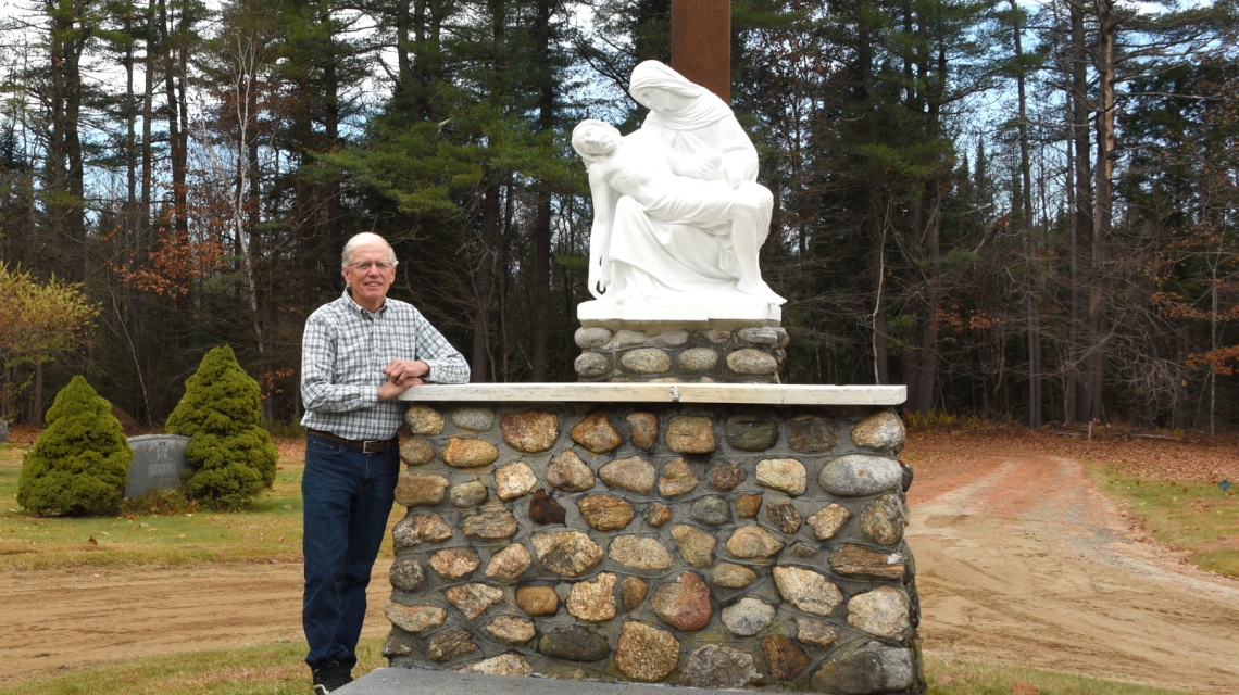 George Janosco standing next to the pietà