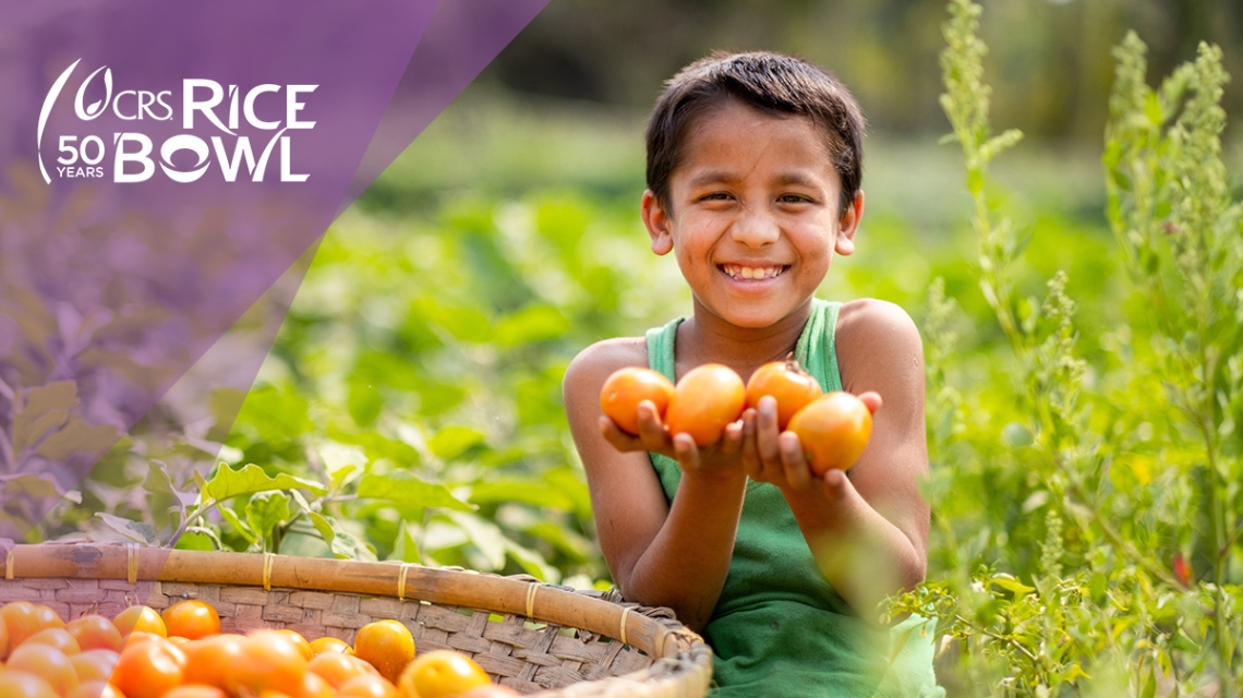 Little boy holding vegetables.