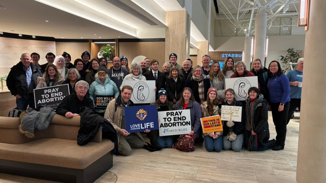 Group posed together in a hotel lobby