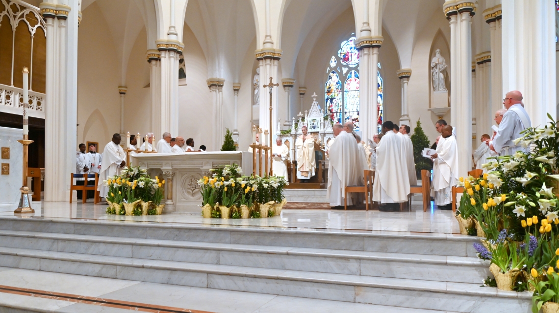 Bishop James Ruggieri and priests in the sanctuary of the cathedral