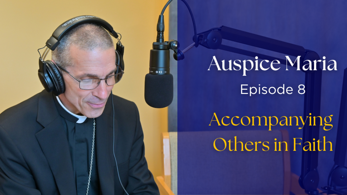 Bishop Ruggieri sitting in front of a microphone. text: "Auspice Maria, Episode 8, Accompanying others in faith"