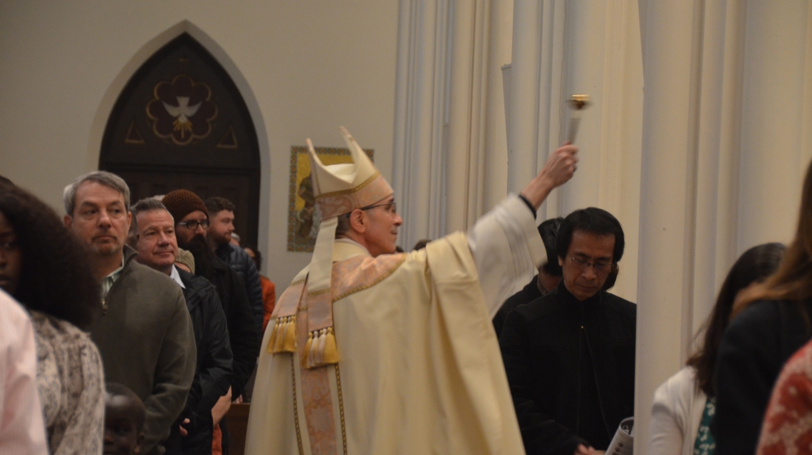 Bishop blesses congregation with holy water
