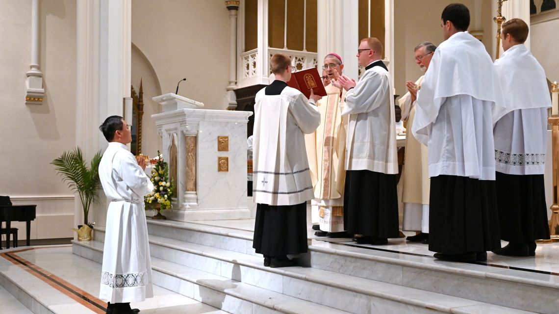 Bishop James Ruggieri prays the Prayer of Ordination.