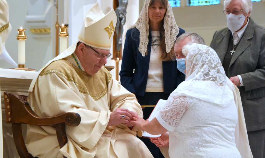 Bishop Robert Deeley presents Angela McCormick with a ring as a sign of her consecration.