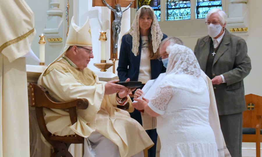 Bishop Robert Deeley presents Angela McCormick with a book of the Liturgy of the Hours