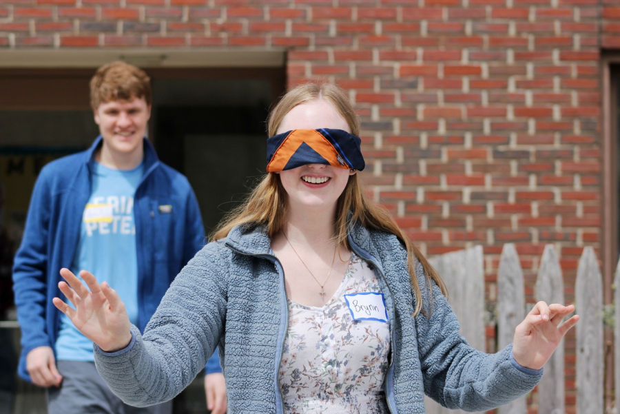 Teen participating in blindfold game.