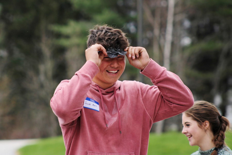 Teen participating in blindfold competition.