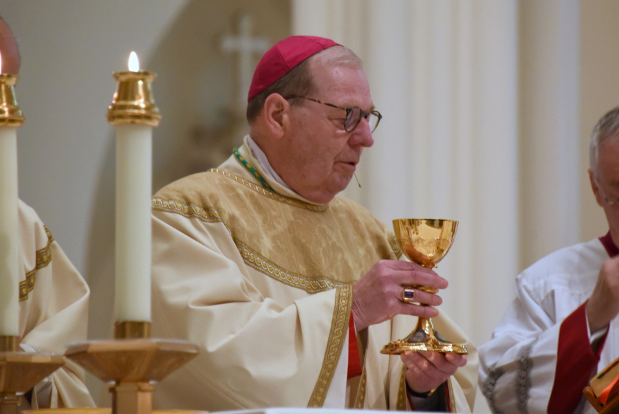 Bishop Robert Deeley holds up the chalice