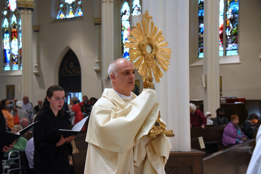 Father Seamus Griesbach carries the monstrance.