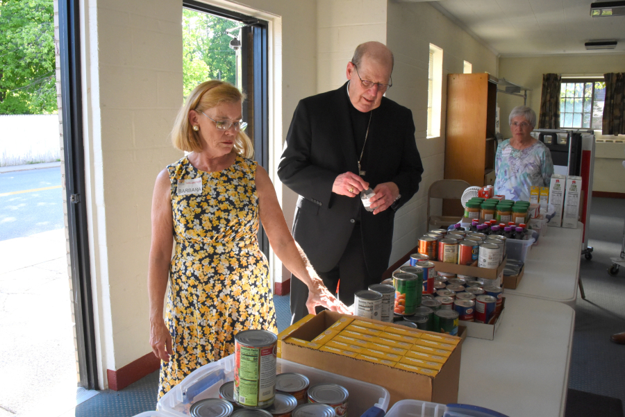 Bishop Deeley tours the food closet.