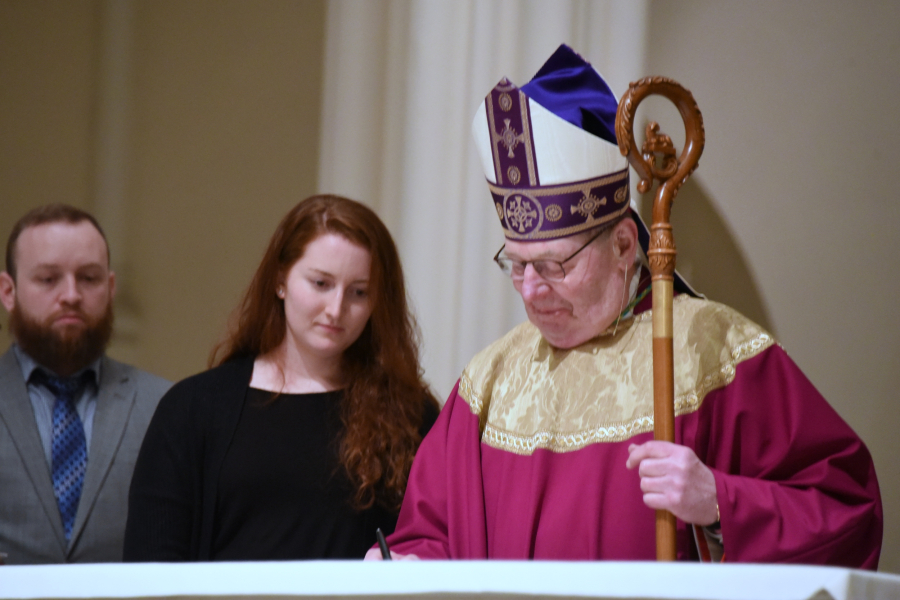 Bishop Robert Deeley signs Book of the Elect