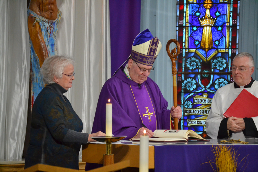 Bishop Deeley Signs a Book of the Elect