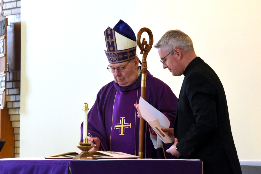 Bishop Deeley Signs Book of the Elect