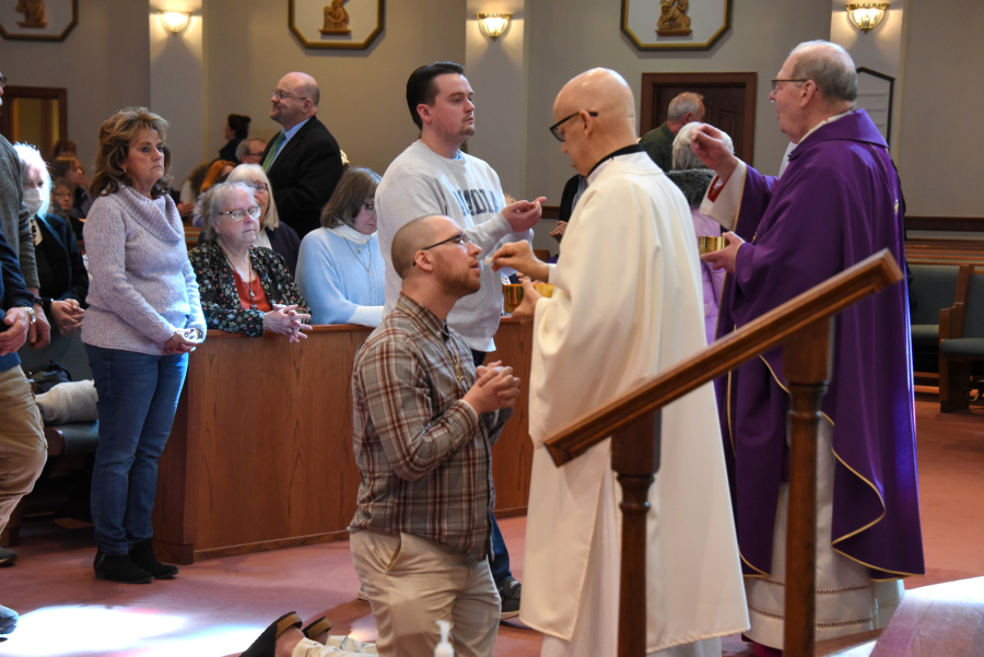 Deacon Daniel Mahoney gives Communion