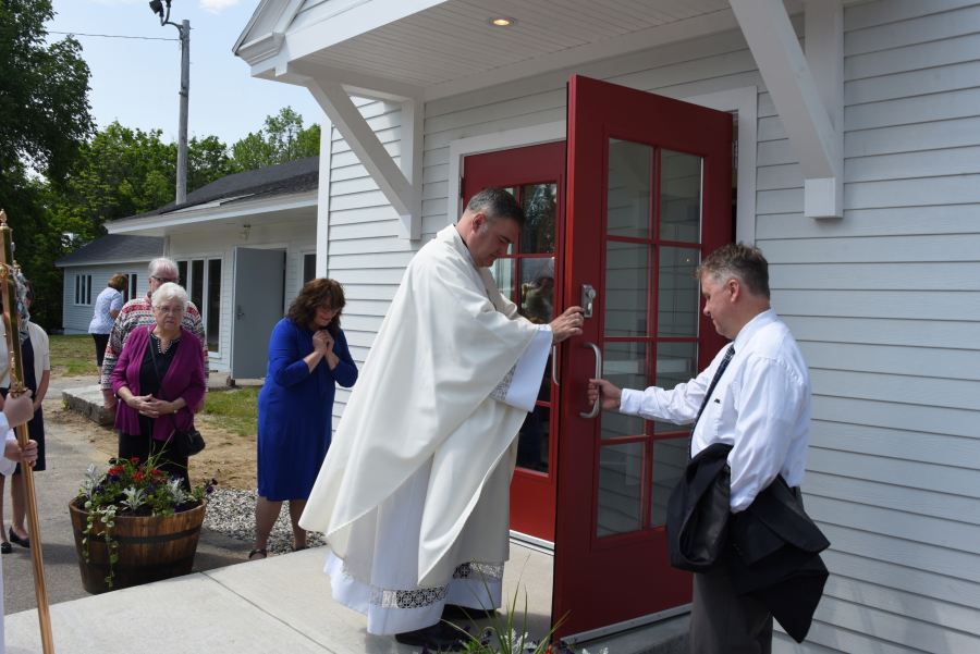 Father Ed Clifford opens the doors of the church.