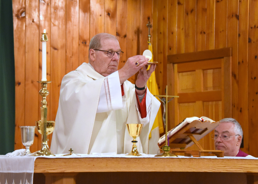 Bishop Deeley holds up the host during consecration.