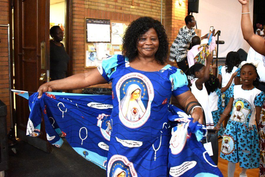 Woman displaying dress with image of the Blessed Mother