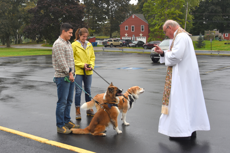 Father Conley blesses two dogs