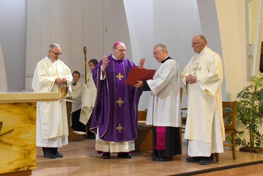 Bishop Robert Deeley blesses the water. Deacon Rodney Deschaine stands to the bishop's right. Msgr. Marc Caron and Deacon Don Clavette are to his left.