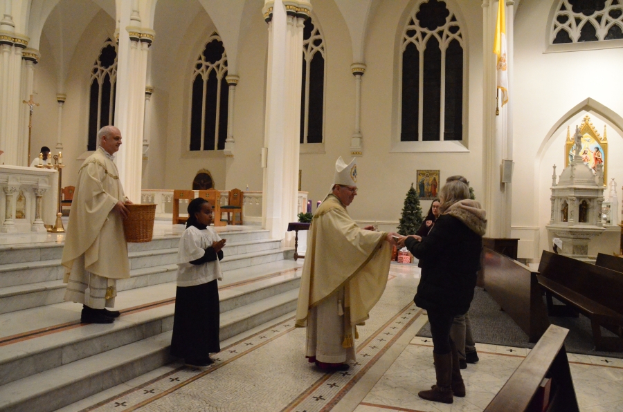 The bishop receives the gift in front of the altar