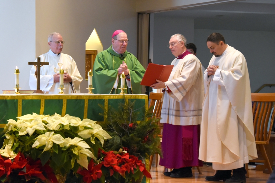 Bishop Robert Deeley delivers the opening prayer. To his left his Deacon Frank Daggett. To his right is Msgr. Marc Caron and Fr. Paul Dumais.
