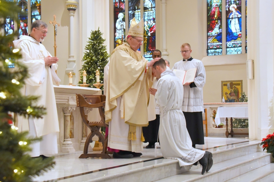 The bishop lays hands on Matthew Valles.