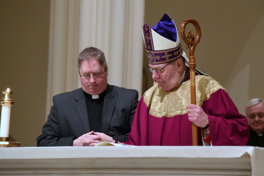 Bishop signs Book of the Elect for Good Shepherd Parish.