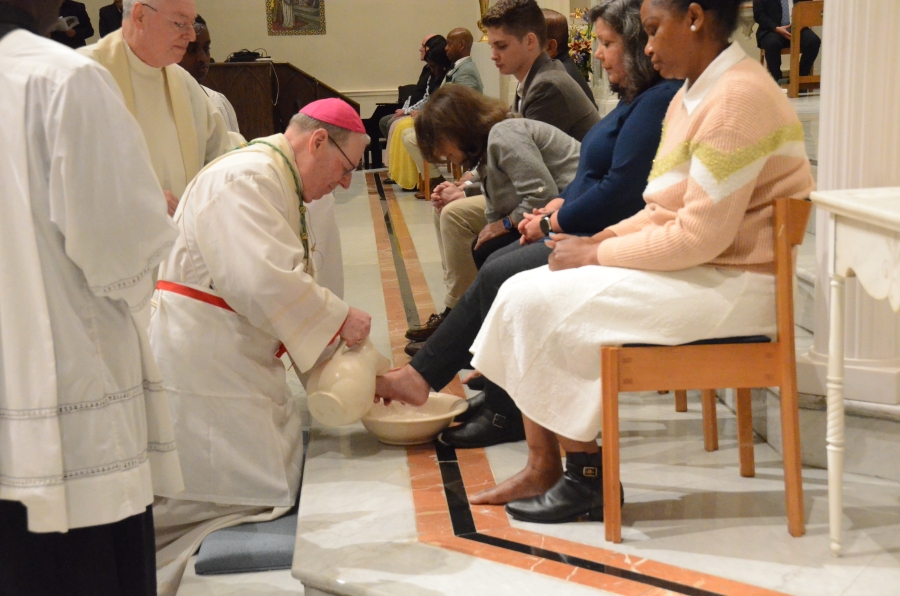 Bishop washes feet of woman